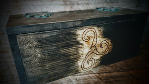 Front view of rustic alter box with triskelion wood burn.